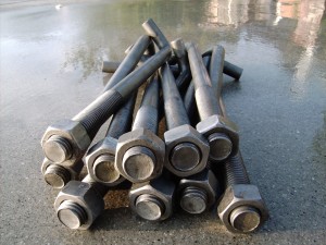 Anchor bolts, F1554 grade 36, with hex nuts on concrete before installation in concrete for civil construction.